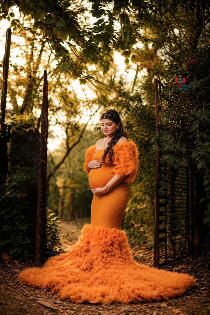 Outdoor maternity portrait with flowing gown by Candid Clicks in Asansol