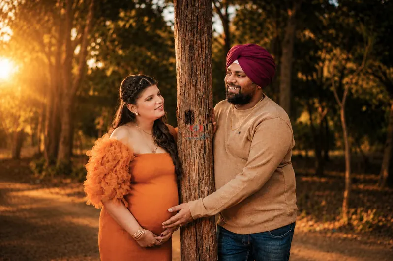 Expecting couple pregnancy portrait in a natural forest setting by Candid Clicks