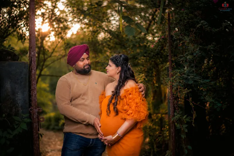 Expecting couple portrait in a misty forest by Candid Clicks
