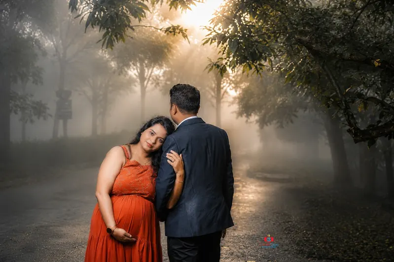 Outdoor maternity family portrait by Candid Clicks in Asansol